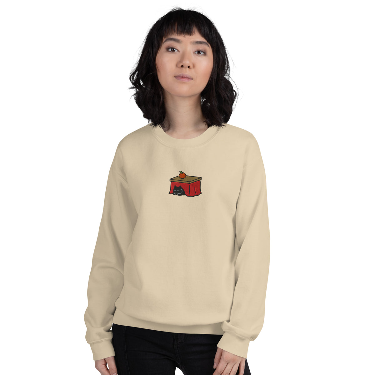 Woman wearing the sand Kotatsu Cat embroidered sweatshirt